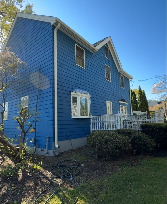 Home exterior painted blue with clean white trim