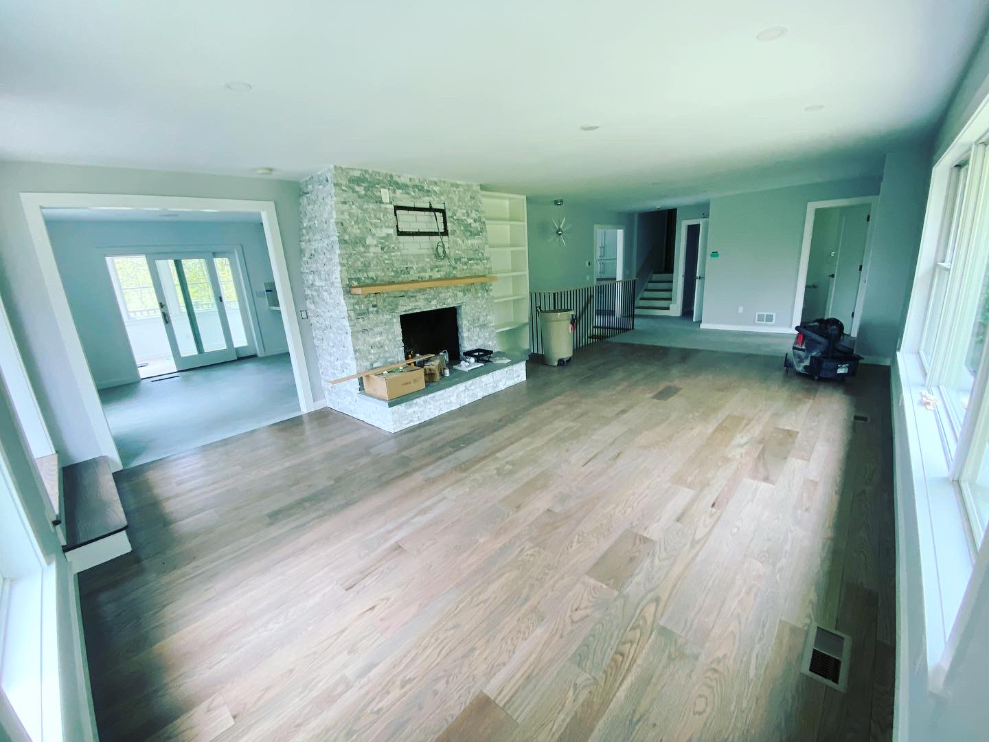 Repainted living room with stone fireplace and refinished hardwood floors in Connecticut